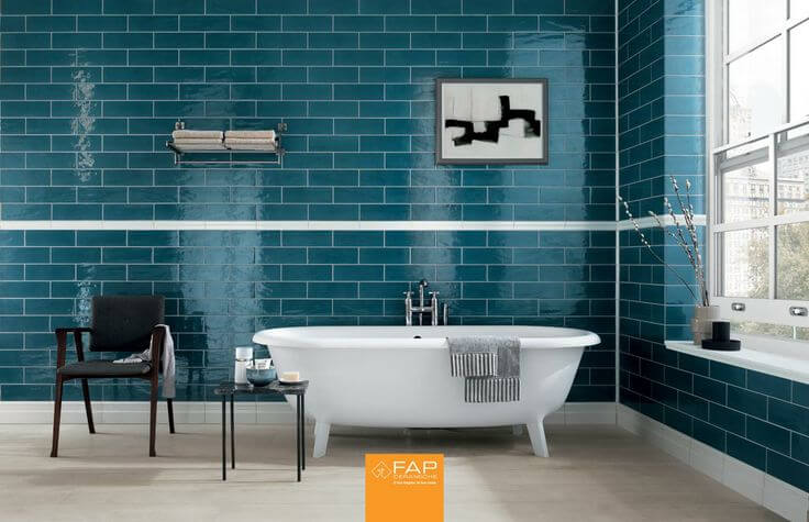 This unique bathroom has an aqua colored tile along the walls. The aqua against the light hardwood flooring the glistening white bathtub adds a striking atmosphere in this space. This unique bathroom has an aqua colored tile along the walls. The aqua against the light hardwood flooring the glistening white bathtub adds a striking atmosphere in this space.