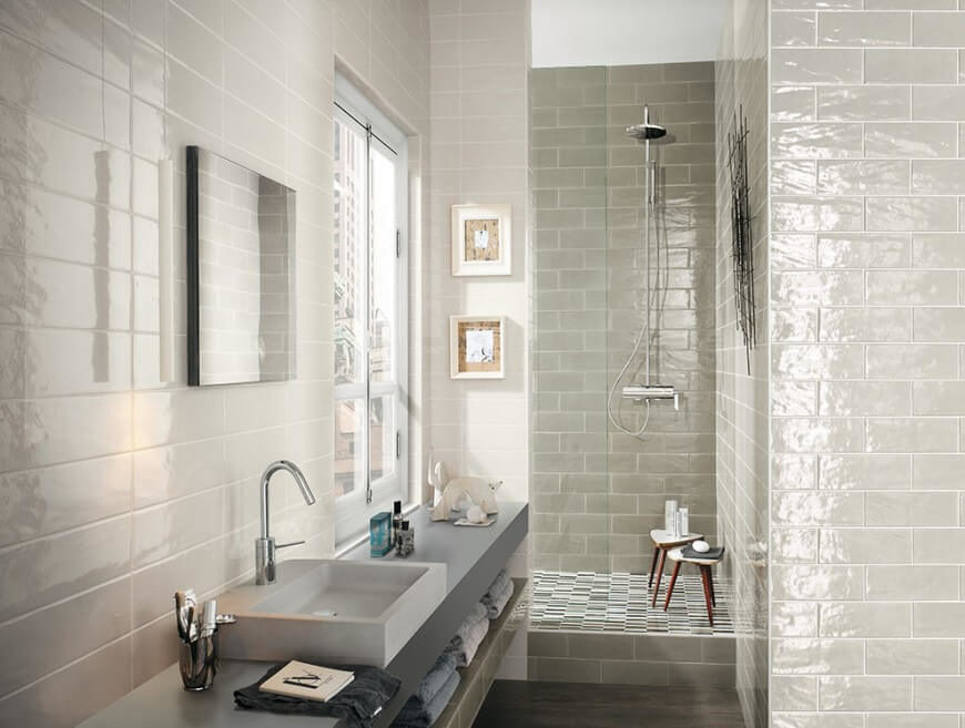 This quaint bathroom has small wooden stools in the shower for extra storage space. The vessel sink is a unique square shape for geometrical touch to this room. This quaint bathroom has small wooden stools in the shower for extra storage space. The vessel sink is a unique square shape for geometrical touch to this room.