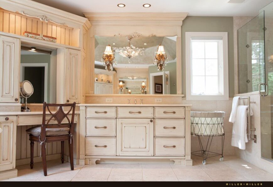 The same bathroom from a different angle exposes the quaint vanity and the rustic country textures on the wood. Elegant lights on the mirror create a classic atmosphere. The same bathroom from a different angle exposes the quaint vanity and the rustic country textures on the wood. Elegant lights on the mirror create a classic atmosphere.