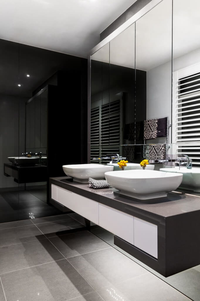 This chic design features a contemporary black and white color scheme. The square shaped vessel sinks really add to the modern look of this bathroom. This chic design features a contemporary black and white color scheme. The square shaped vessel sinks really add to the modern look of this bathroom.