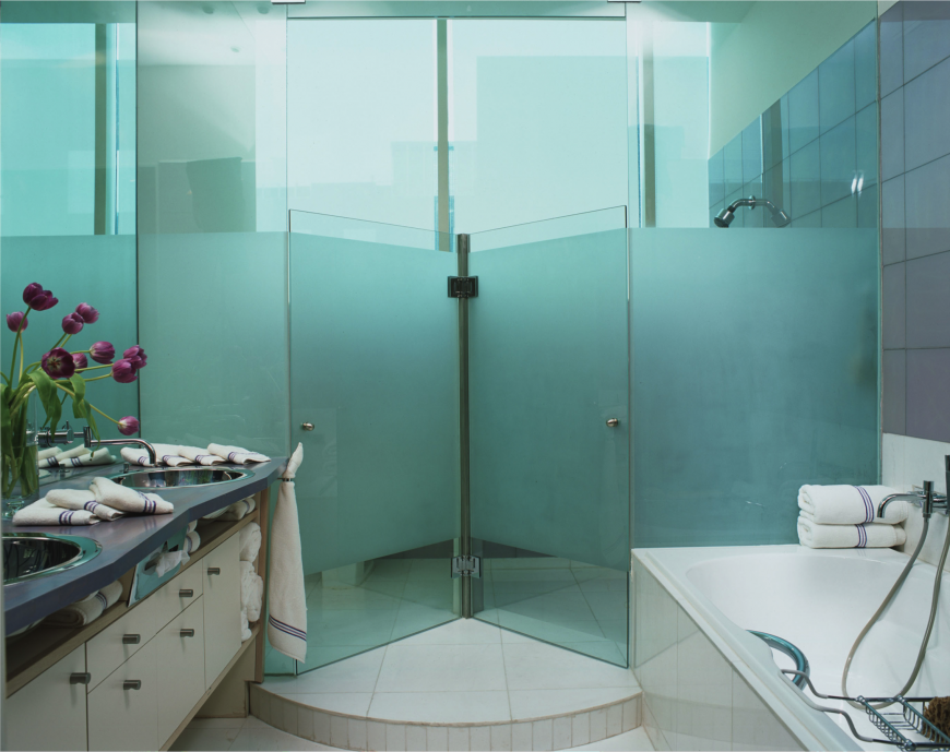 This bathroom has a interesting design with a gorgeous and sleek vanity with lots of storage space.. A unique revolving glass door spins around into the shower. This bathroom has a interesting design with a gorgeous and sleek vanity with lots of storage space.. A unique revolving glass door spins around into the shower.