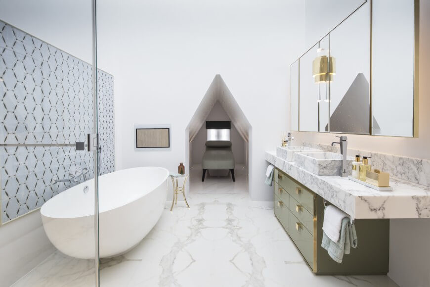 This striking bathroom is full of soft light. The marble floor moves all the way to a small resting nook at the end of the bathroom. This striking bathroom is full of soft light. The marble floor moves all the way to a small resting nook at the end of the bathroom.