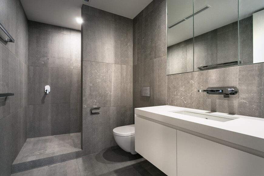 This entire bathroom has large format tile all around. The shower does not have a door, and gives a very open and spacious feeling to this room. This entire bathroom has large format tile all around. The shower does not have a door, and gives a very open and spacious feeling to this room.