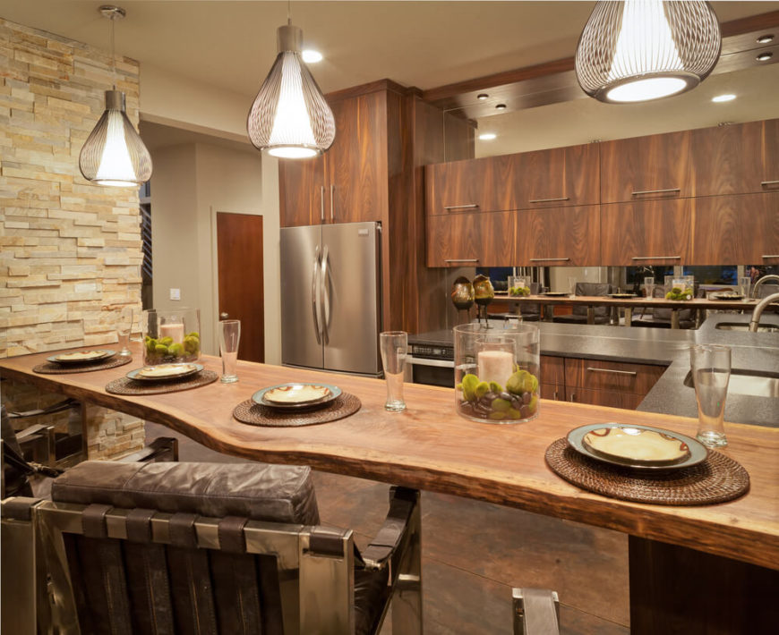 While it's connected to a free standing dividing wall, we'll still count this unique creation as a kitchen island. A single large slab of natural carved wood makes for abundant in-kitchen dining space, while helping define the natural wood kitchen itself. While it's connected to a free standing dividing wall, we'll still count this unique creation as a kitchen island. A single large slab of natural carved wood makes for abundant in-kitchen dining space, while helping define the natural wood kitchen itself.