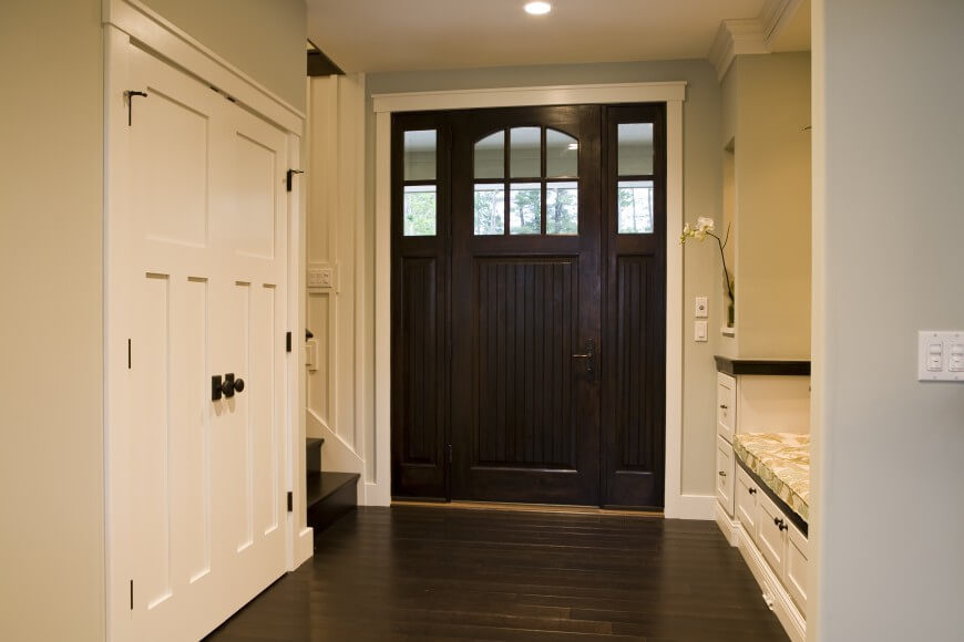 This lovely foyer utilizes dark wood to ground the small space. A built-in bench and shelf area is a smart use of functional space in such a small area. This lovely foyer utilizes dark wood to ground the small space. A built-in bench and shelf area is a smart use of functional space in such a small area.