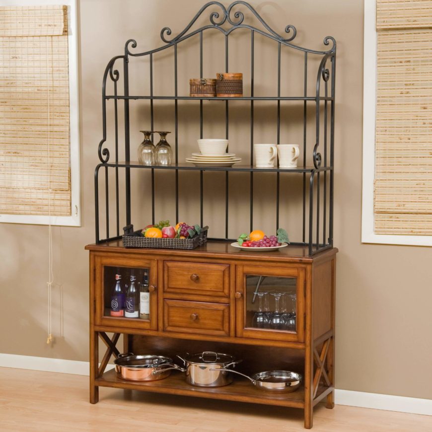 While the wrought iron shelves are used as an attractive display, the bottom is used as a mini bar and as a pot rack. While the wrought iron shelves are used as an attractive display, the bottom is used as a mini bar and as a pot rack.