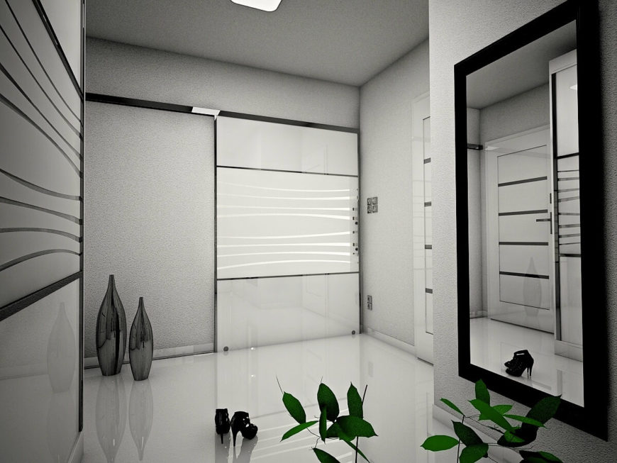 Luxurious foyer with decorative frosted glass panels along the gray walls. It has a full-length mirror and modern vases that add elegance to the entryway.
