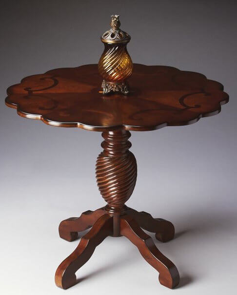 The scalloped edges of this ornate, round foyer table announces elegance and opulence, giving guests a taste of the rest of your home. The scalloped edges of this ornate, round foyer table announces elegance and opulence, giving guests a taste of the rest of your home.