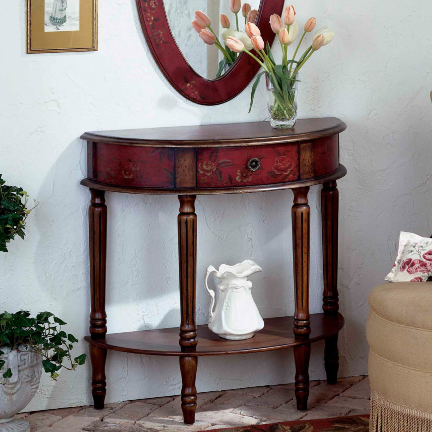 Floral inlays on the front of this lovely red and rich wood foyer table add a delicate side to this elegant piece. A single drawer on the front is perfect for holding small items. Floral inlays on the front of this lovely red and rich wood foyer table add a delicate side to this elegant piece. A single drawer on the front is perfect for holding small items.