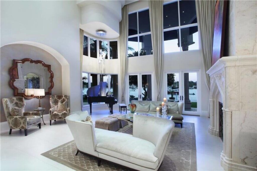 This living room features three intimate spaces that are perfect for groups of two, including a set of wing-back chairs, a loveseat, and a chaise with a back on either side. This living room features three intimate spaces that are perfect for groups of two, including a set of wing-back chairs, a loveseat, and a chaise with a back on either side.