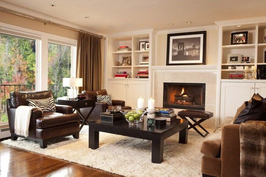 The built-in shelves on either side of the fireplace are filled with books and family photos, with a photograph above the mantle as well. The built-in shelves on either side of the fireplace are filled with books and family photos, with a photograph above the mantle as well.