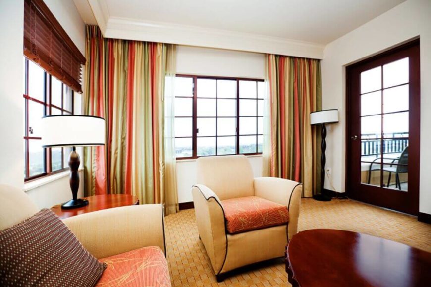 Multi-colored curtains add warmth to the light color pallet, and lengthen the walls. Multi-colored curtains add warmth to the light color pallet, and lengthen the walls.