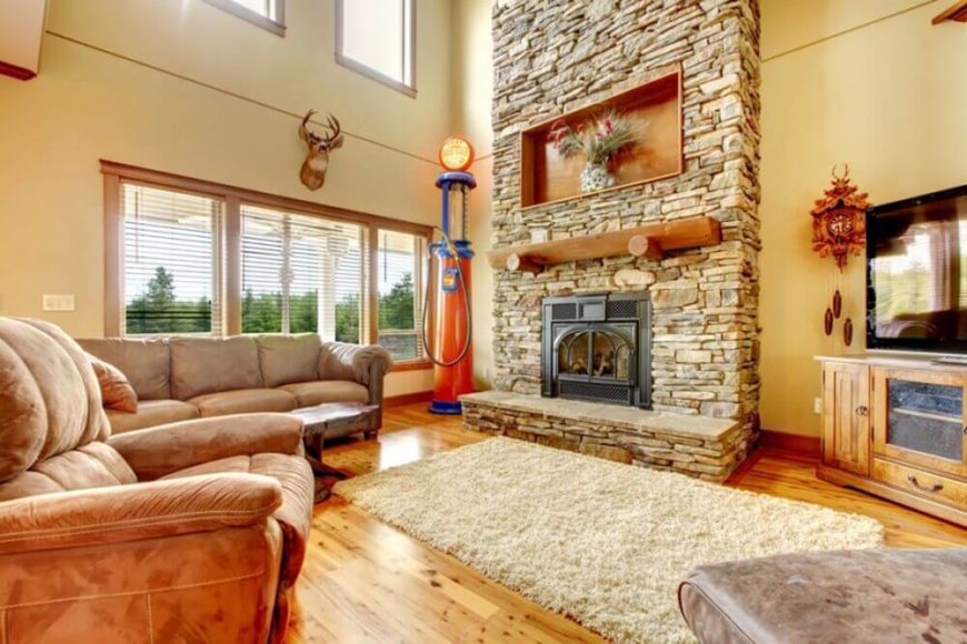 A few unique pieces, including a hunting trophy, cuckoo clock, and an old gas pump, are unexpected additions to this rustic-contemporary living room. A few unique pieces, including a hunting trophy, cuckoo clock, and an old gas pump, are unexpected additions to this rustic-contemporary living room.