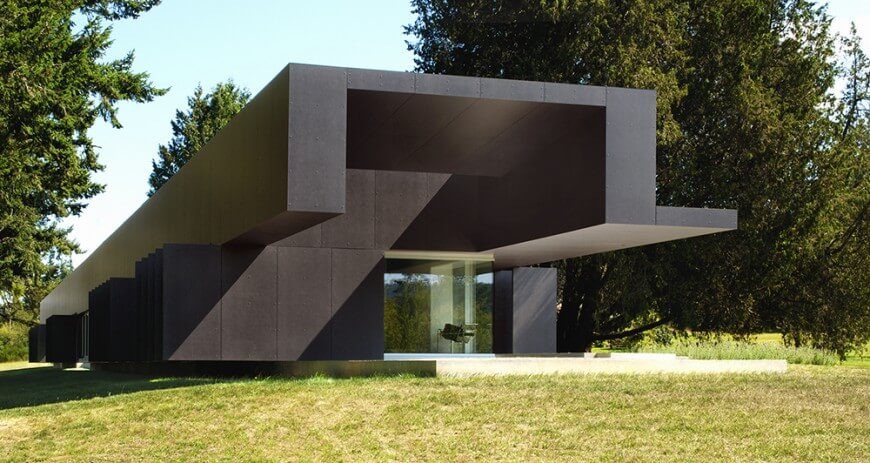 Fiber cement can be tinted to nearly any color and often time comes with a 50 year warranty with little to no maintenance. Special ordering them in a particular color is ideal as factory painting is guaranteed for up to 25 years. This completely modern structure's exterior is covered in charcoal colored fiber cement panels. Fiber cement can be tinted to nearly any color and often time comes with a 50 year warranty with little to no maintenance. Special ordering them in a particular color is ideal as factory painting is guaranteed for up to 25 years. This completely modern structure's exterior is covered in charcoal colored fiber cement panels.