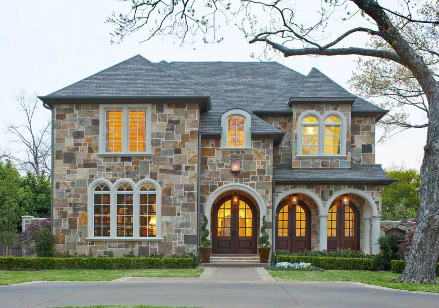 Not to be outdone, quarries created a method of making thin sheets of stone. This made stone easier to carry and install, thus making it a bit more affordable. This multi-colored stone house makes a striking show with its puzzle-piece like exterior. Not to be outdone, quarries created a method of making thin sheets of stone. This made stone easier to carry and install, thus making it a bit more affordable. This multi-colored stone house makes a striking show with its puzzle-piece like exterior.