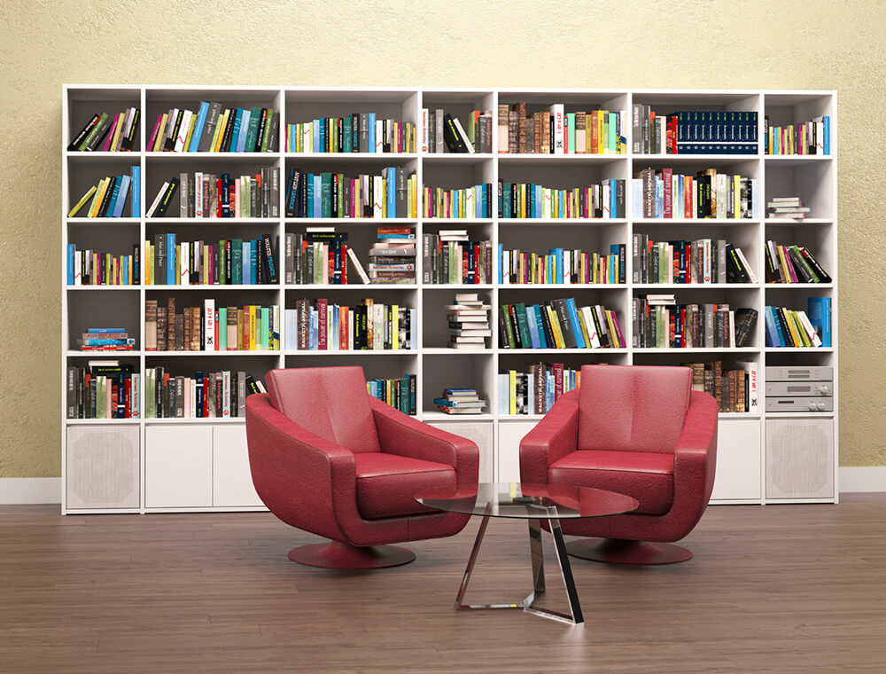 The red seats set on the hardwood flooring of this home library look so perfect together with the white bookshelves set on the back.
