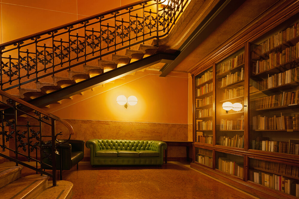 A stunning home library with romantic warm white lights. The bookshelves are just enchanting.