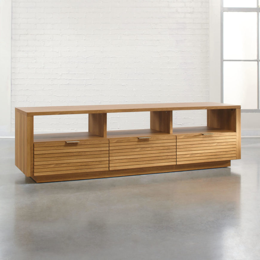 This elegant, modern natural oak set boasts a simple, minimalist design that offers abundant utility and gets out of the way. A piece like this can be used simply as a TV stand, but can also supply abundant display shelving above its storage when you have the TV itself mounted on the wall above. This elegant, modern natural oak set boasts a simple, minimalist design that offers abundant utility and gets out of the way. A piece like this can be used simply as a TV stand, but can also supply abundant display shelving above its storage when you have the TV itself mounted on the wall above.