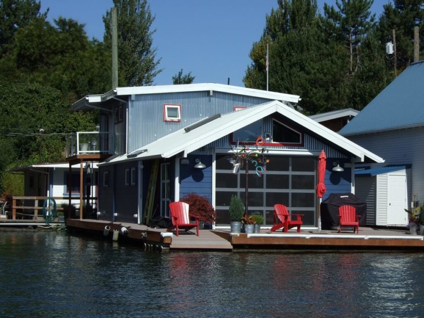 A very large and luxurious permanently moored house boat in a gorgeous blue. Red trim and accents stand out against the large window on the front. A very large and luxurious permanently moored house boat in a gorgeous blue. Red trim and accents stand out against the large window on the front.