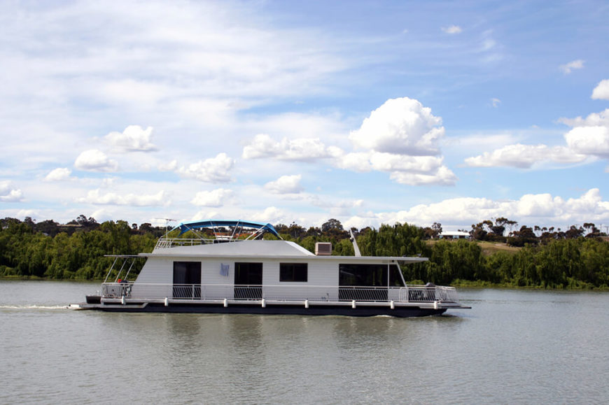 A large leisure houseboat designed to troll along the quiet lakes of North America. This is a large craft that is almost entirely cabin, with a perimeter of balustrade around the exterior and a large covered deck on top. A large leisure houseboat designed to troll along the quiet lakes of North America. This is a large craft that is almost entirely cabin, with a perimeter of balustrade around the exterior and a large covered deck on top.