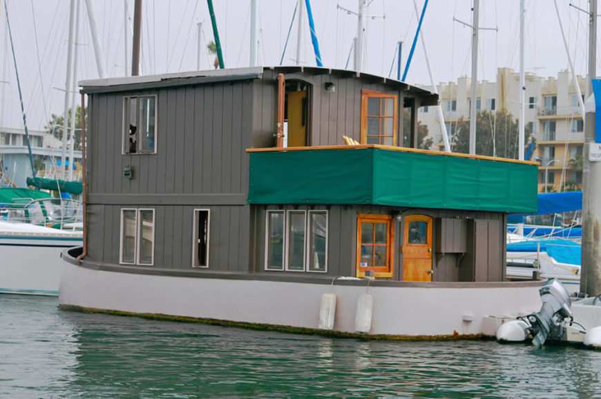 Another permanently moored houseboat located in a large coastal marina. The home is two stories, with plenty of windows and a balcony. Another permanently moored houseboat located in a large coastal marina. The home is two stories, with plenty of windows and a balcony.