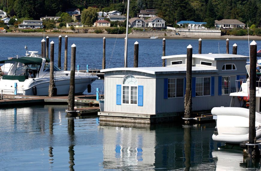 This houseboat is moored at a marina, and resembles a pre-fabricated home placed on top of a large raft. This houseboat is moored at a marina, and resembles a pre-fabricated home placed on top of a large raft.