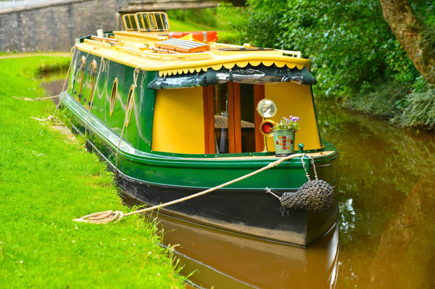 A brightly colored quaint houseboat with no open air deck. The boat is perfect for maneuvering through the canals of the Netherlands. A brightly colored quaint houseboat with no open air deck. The boat is perfect for maneuvering through the canals of the Netherlands.