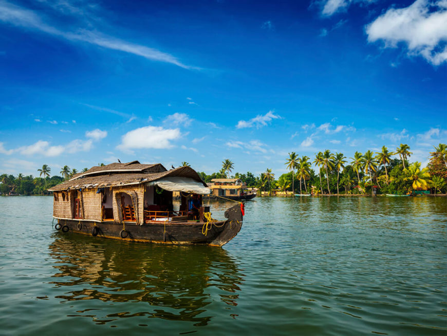 This houseboat in Kerala is moving slowly down a wide river, perfect for sight seeing. This houseboat in Kerala is moving slowly down a wide river, perfect for sight seeing.