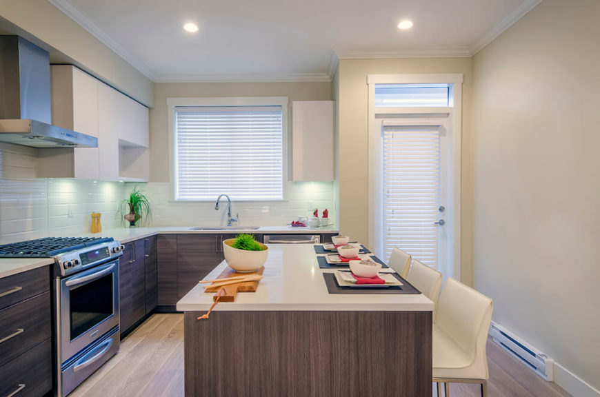 Cream colored chairs match the countertops and the upper cabinets while weathered wood makes up the bottom in the modern-contemporary kitchen. Splashes of red and bright green bring more, simple color into the space to spice it up. Cream colored chairs match the countertops and the upper cabinets while weathered wood makes up the bottom in the modern-contemporary kitchen. Splashes of red and bright green bring more, simple color into the space to spice it up.