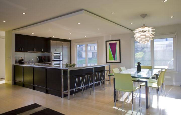 Contemporary kitchen with a shade of dark counter and cabinetry along with a dine-in table set and a breakfast bar space.