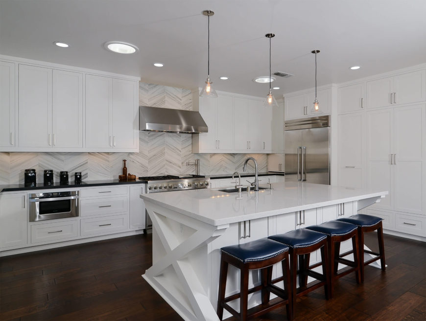 Smart Appliances Large kitchen with hardwood floors and white cabinetry along with stylish backsplash and smart appliances.