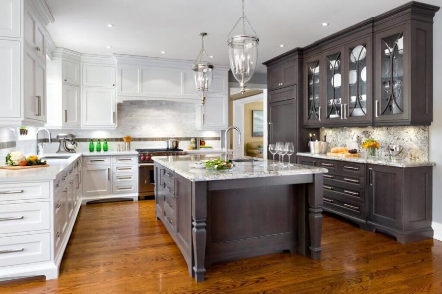 U-shape kitchen with hardwood flooring and a large center island with mixed white and dark brown cabinetry.