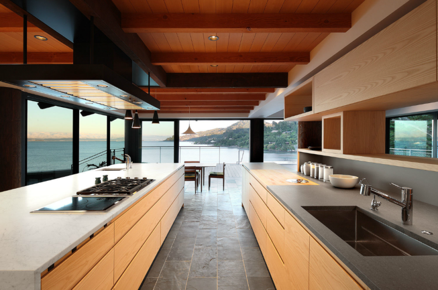 Galley type kitchen with smooth countertops and hardwood cabinetry along with tiles flooring and smart appliances.