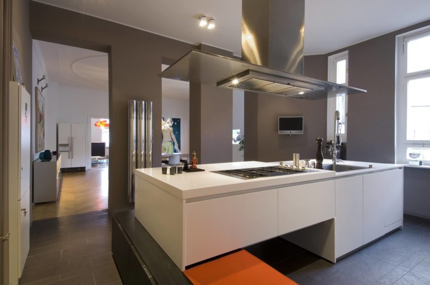 Modern kitchen with gray walls and white large center island.