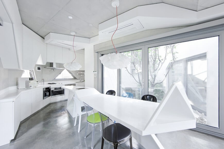 Our final kitchen is an astonishing modern creation focused on irregular geometric shapes. Bold white colors the island, countertops, and cabinetry while soft grey informs the flooring. Bright natural light pours in through massive full height windows, reflecting off the subtly powerful stainless steel appliances. Our final kitchen is an astonishing modern creation focused on irregular geometric shapes. Bold white colors the island, countertops, and cabinetry while soft grey informs the flooring. Bright natural light pours in through massive full height windows, reflecting off the subtly powerful stainless steel appliances.
