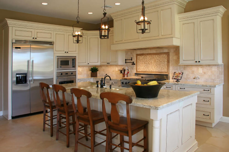 We love the large, stately island in this kitchen, topped with light granite and sporting both a large sink and plenty of space for in-kitchen dining. The stainless steel appliances add a sleek counterpoint to the soft tones of the room. We love the large, stately island in this kitchen, topped with light granite and sporting both a large sink and plenty of space for in-kitchen dining. The stainless steel appliances add a sleek counterpoint to the soft tones of the room.