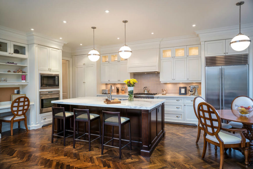 Rich, dark stained hardwood flooring contrasts with pristine white cabinetry in this large, open design kitchen. Stainless steel appliances add a flash of sleek modernism, but the whole room is anchored by the dark wood island with marble countertop. Rich, dark stained hardwood flooring contrasts with pristine white cabinetry in this large, open design kitchen. Stainless steel appliances add a flash of sleek modernism, but the whole room is anchored by the dark wood island with marble countertop.