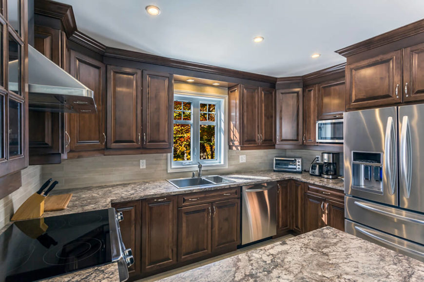 Here's another fine example of the bold contrast and modernity that stainless steel appliances can inject into a traditionally styled kitchen. The granite countertops and stone tile backsplash convey a neutral tone across the center. Here's another fine example of the bold contrast and modernity that stainless steel appliances can inject into a traditionally styled kitchen. The granite countertops and stone tile backsplash convey a neutral tone across the center.
