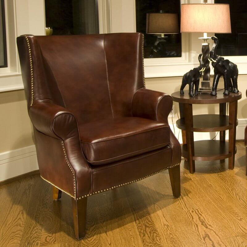 This handsome, top grain leather chair provides an image of sophistication and tradition. With classically styled roll arms, antiqued brass nail head accents, and simple, solid wood feet, this is a beautiful chair that doesn't come off as too extravagant or oversized. This handsome, top grain leather chair provides an image of sophistication and tradition. With classically styled roll arms, antiqued brass nail head accents, and simple, solid wood feet, this is a beautiful chair that doesn't come off as too extravagant or oversized.