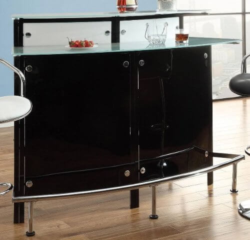 If your man cave leans toward the more elegant, modern end of style, this could be the perfect home bar setup. Glossy black cabinetry, chromed foot rails and hardware, and a tempered glass bar top make for a uniquely rich textural presence. The two-tiered bar makes for plenty of space to mix, pour, and serve drinks, while the glossy look will emphasize a sense of luxury in any modern man cave.
