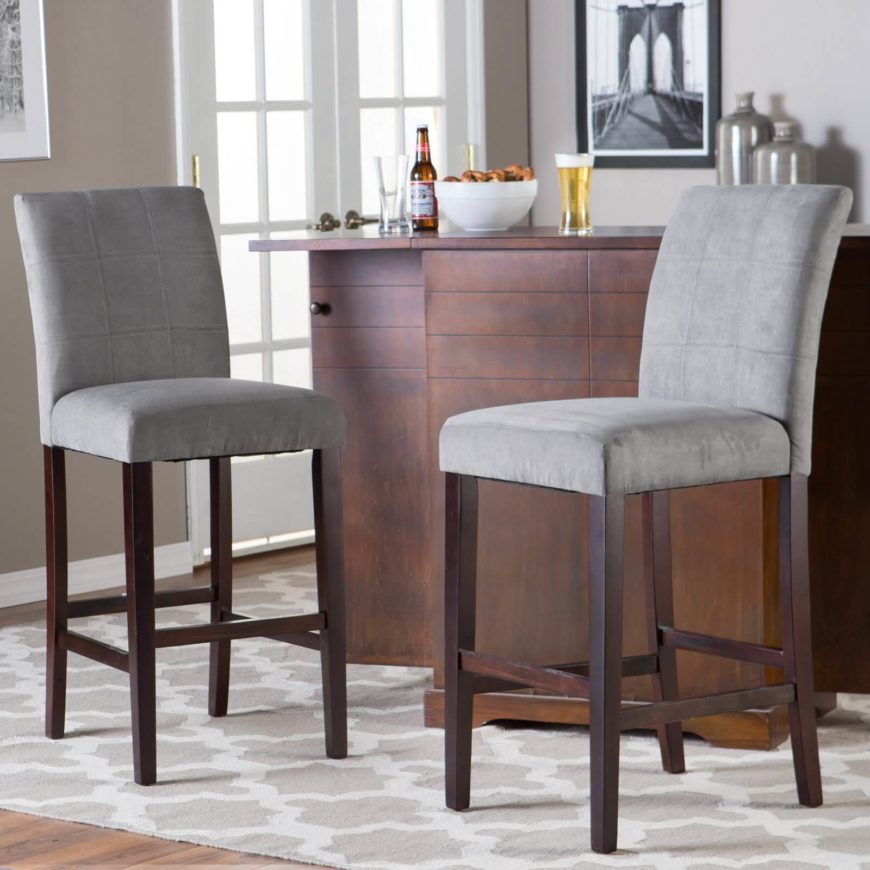 We come full circle back to a sleek and simple contemporary design for our last man cave bar stool. This elegant design features soft grey upholstery over a rich, dark wood frame for a lightly contrasting look that would be at home in rooms of a variety of styles. It's close enough to neutral to fit in with a traditional man cave, but svelte enough to work wonders in a more modern setting. The high back is a great addition for ultimate comfort.