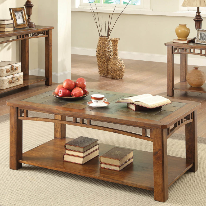 Here's another elegant, rich wood coffee table with a subtle but gorgeous accent in the tabletop. Here we see slate tiles encompassing most of the surface area, framed in thick wood beams all around. The table features a bit of ornamentation around the edges, strung between the legs, but it's unfussy and sleek, remaining true to the style. Here's another elegant, rich wood coffee table with a subtle but gorgeous accent in the tabletop. Here we see slate tiles encompassing most of the surface area, framed in thick wood beams all around. The table features a bit of ornamentation around the edges, strung between the legs, but it's unfussy and sleek, remaining true to the style.