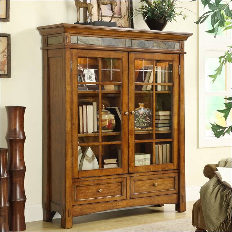 Standing at the opposite end of functionality from or prior set of shelving, this model features the familiar touch of a slate accent, wrapping around the top of the structure above a pair of large glass doors that enclose the majority of the unit. This makes for a great protective space where your books and items can be proudly displayed in simple, elegant fashion. Standing at the opposite end of functionality from or prior set of shelving, this model features the familiar touch of a slate accent, wrapping around the top of the structure above a pair of large glass doors that enclose the majority of the unit. This makes for a great protective space where your books and items can be proudly displayed in simple, elegant fashion.