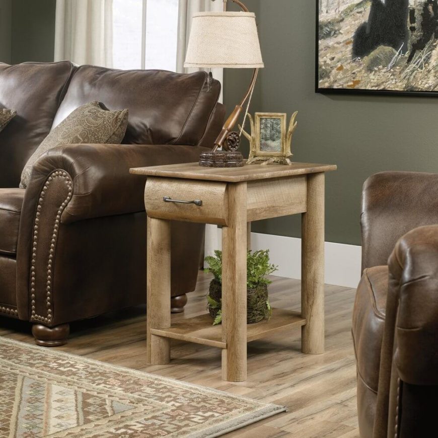 Matching one of our coffee table choices above, this rustic styled side table would make the perfect complement, uniting a living room with simple curved natural wood elegance and a light tone that works great in contrast to darker furniture. The thick legs and unadorned surfaces make for a sturdy, no-nonsense presence in any living room. Matching one of our coffee table choices above, this rustic styled side table would make the perfect complement, uniting a living room with simple curved natural wood elegance and a light tone that works great in contrast to darker furniture. The thick legs and unadorned surfaces make for a sturdy, no-nonsense presence in any living room.