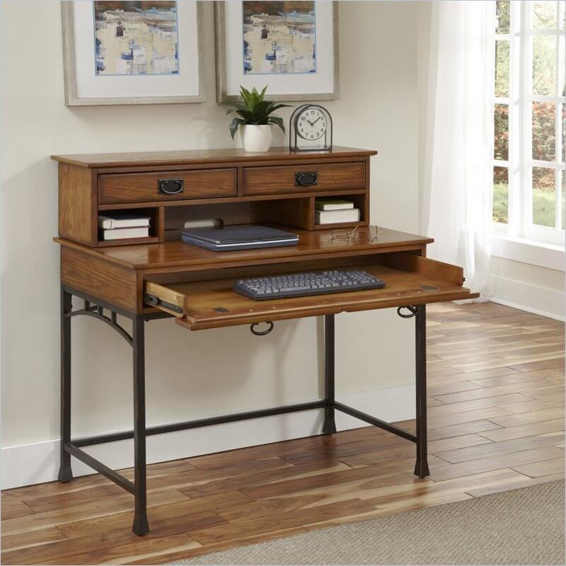Here's a living room desk that's a little more elaborate, with a large desktop set of shelving and drawers that adds an additional layer of functionality and presence to the slim framed desk. A pull-out keyboard surface makes for an elegant solution, keeping the compact frame unobtrusive when not in use. The dark powder coated metal frame acts as the perfect contrast to the warm wood tone. Here's a living room desk that's a little more elaborate, with a large desktop set of shelving and drawers that adds an additional layer of functionality and presence to the slim framed desk. A pull-out keyboard surface makes for an elegant solution, keeping the compact frame unobtrusive when not in use. The dark powder coated metal frame acts as the perfect contrast to the warm wood tone.