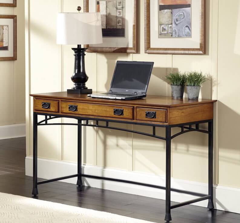 Note the familiar dark powder coated metal framing and slim, but recognizable arches spanning between the legs of this sleek and slim desk, perfectly meshing with the rich oak table top. The wood portion of the desk features a set of discreet drawers, perfect for a little bit of storage when you need it most. Note the familiar dark powder coated metal framing and slim, but recognizable arches spanning between the legs of this sleek and slim desk, perfectly meshing with the rich oak table top. The wood portion of the desk features a set of discreet drawers, perfect for a little bit of storage when you need it most.