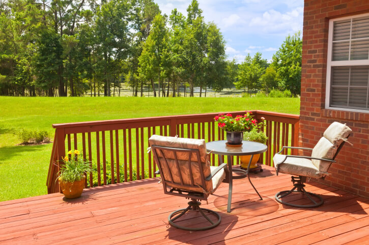 A smaller deck with stairs leading down to the lower section of the yard. A small seating area is positioned perfectly to enjoy the view of the expansive yard that ends in a thin forest. A smaller deck with stairs leading down to the lower section of the yard. A small seating area is positioned perfectly to enjoy the view of the expansive yard that ends in a thin forest.