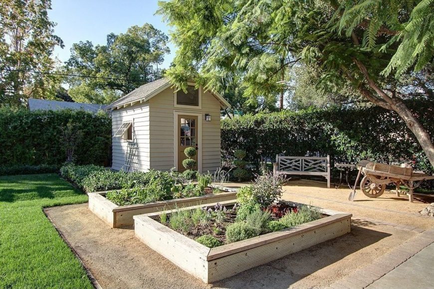 This garden shed is built at the corner of the property, facing the raised wooden beds of vegetables and herbs nearby. The designated garden area is kept visually separate from the grass lawn This garden shed is built at the corner of the property, facing the raised wooden beds of vegetables and herbs nearby. The designated garden area is kept visually separate from the grass lawn