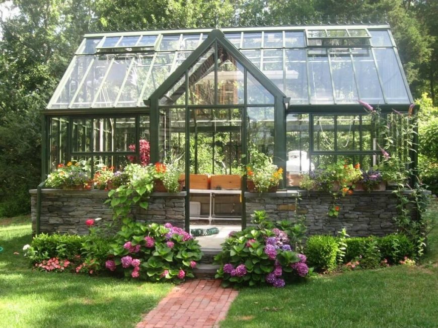 Another lovely greenhouse with green structural beams, but the bottom section is built in stacked stone, giving it an all together different appearance. Another lovely greenhouse with green structural beams, but the bottom section is built in stacked stone, giving it an all together different appearance.