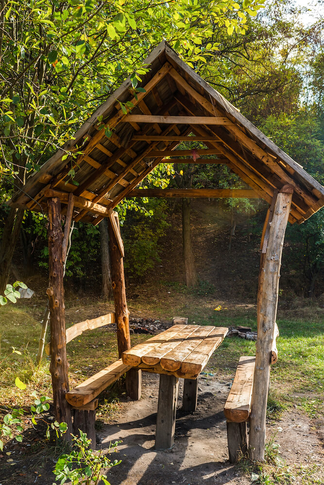 A tiny rustic pavilion with a built-in picnic table. This small area is the perfect spot to stop for a picnic lunch while on a hike. A tiny rustic pavilion with a built-in picnic table. This small area is the perfect spot to stop for a picnic lunch while on a hike.